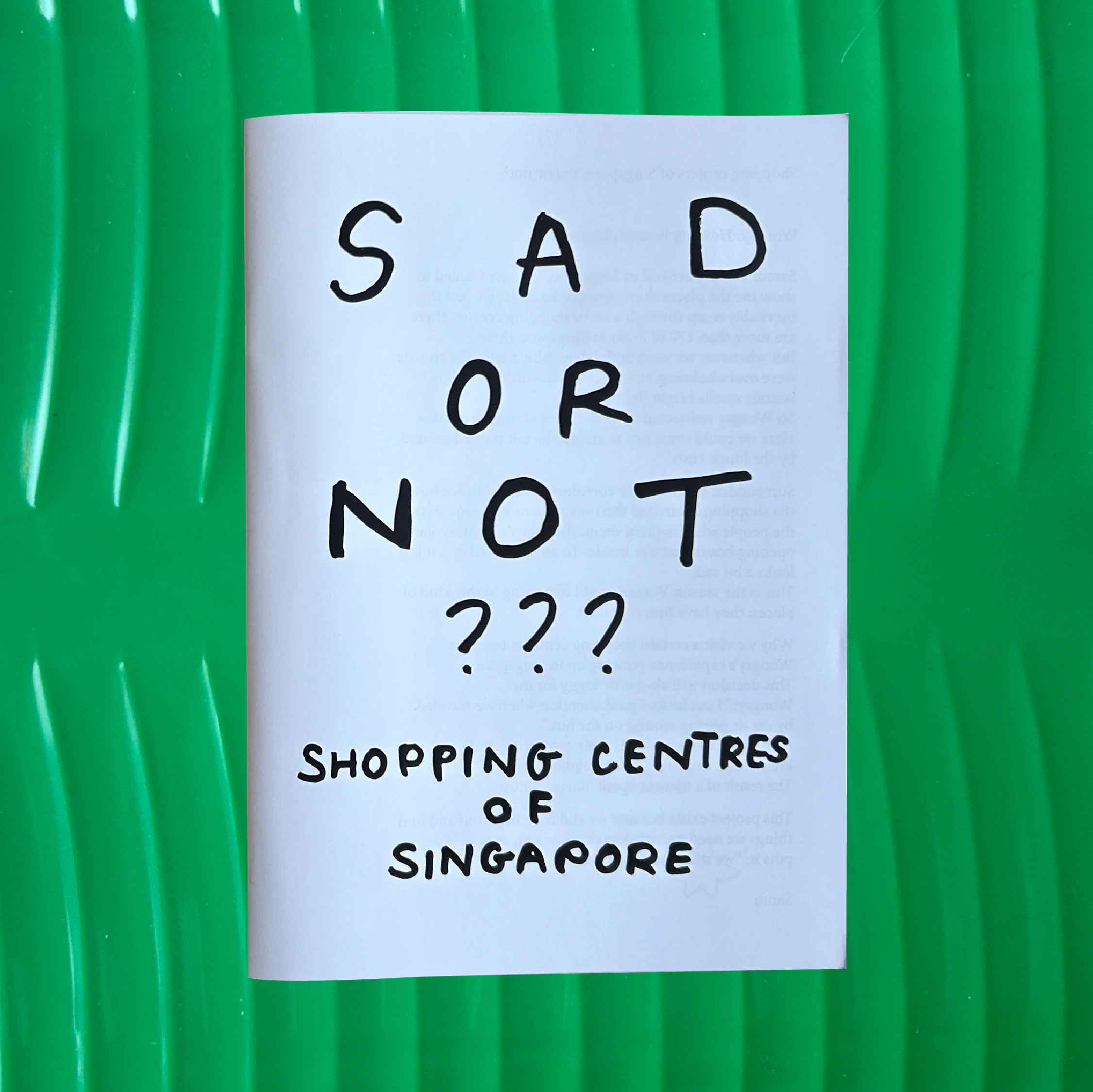 cover of sad or not zine on a fake banana leaf