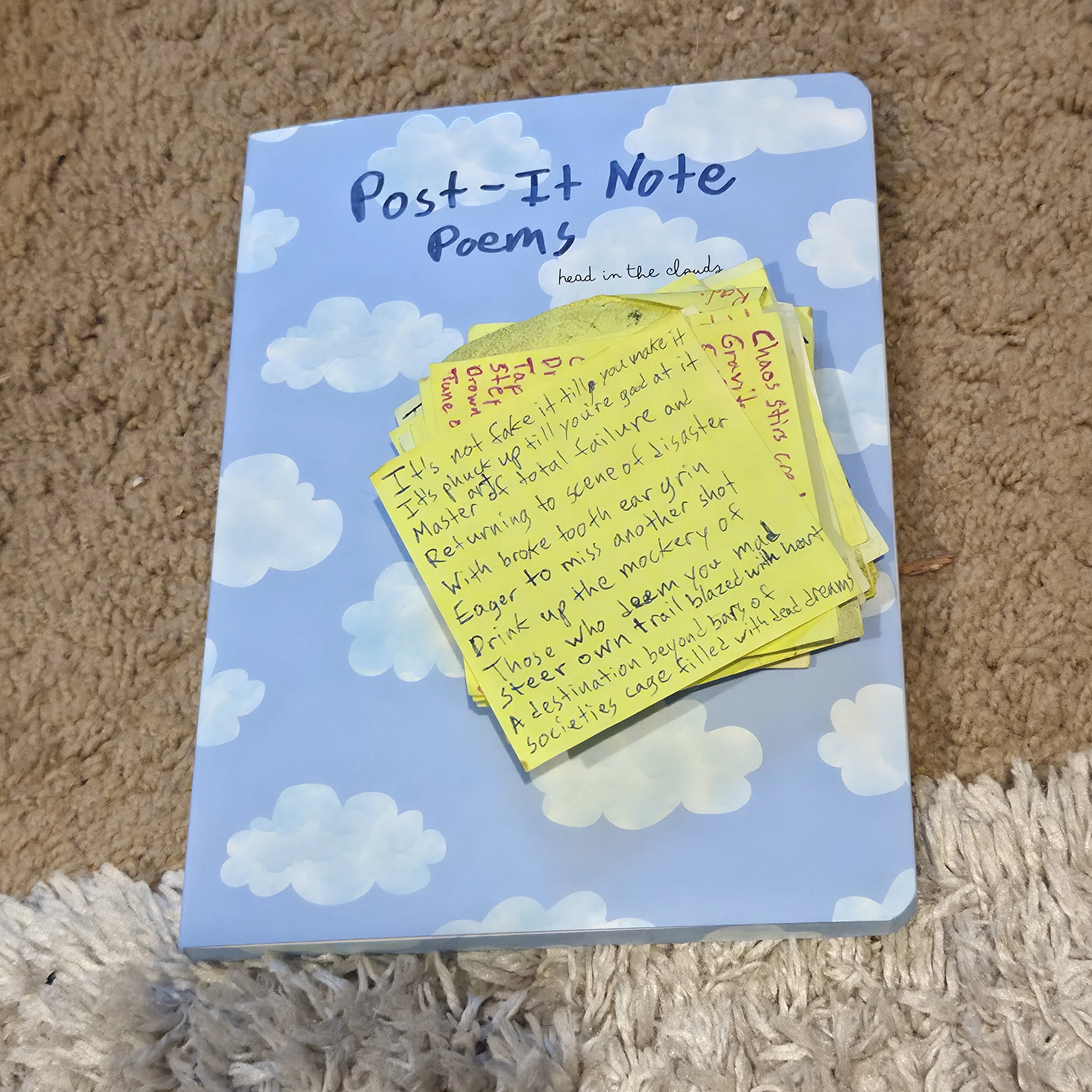 Post-It Note Poems on the notebook that I will be cataloging the poems in. Since every physical one will be raffled off this will be the way that I retain each piece.