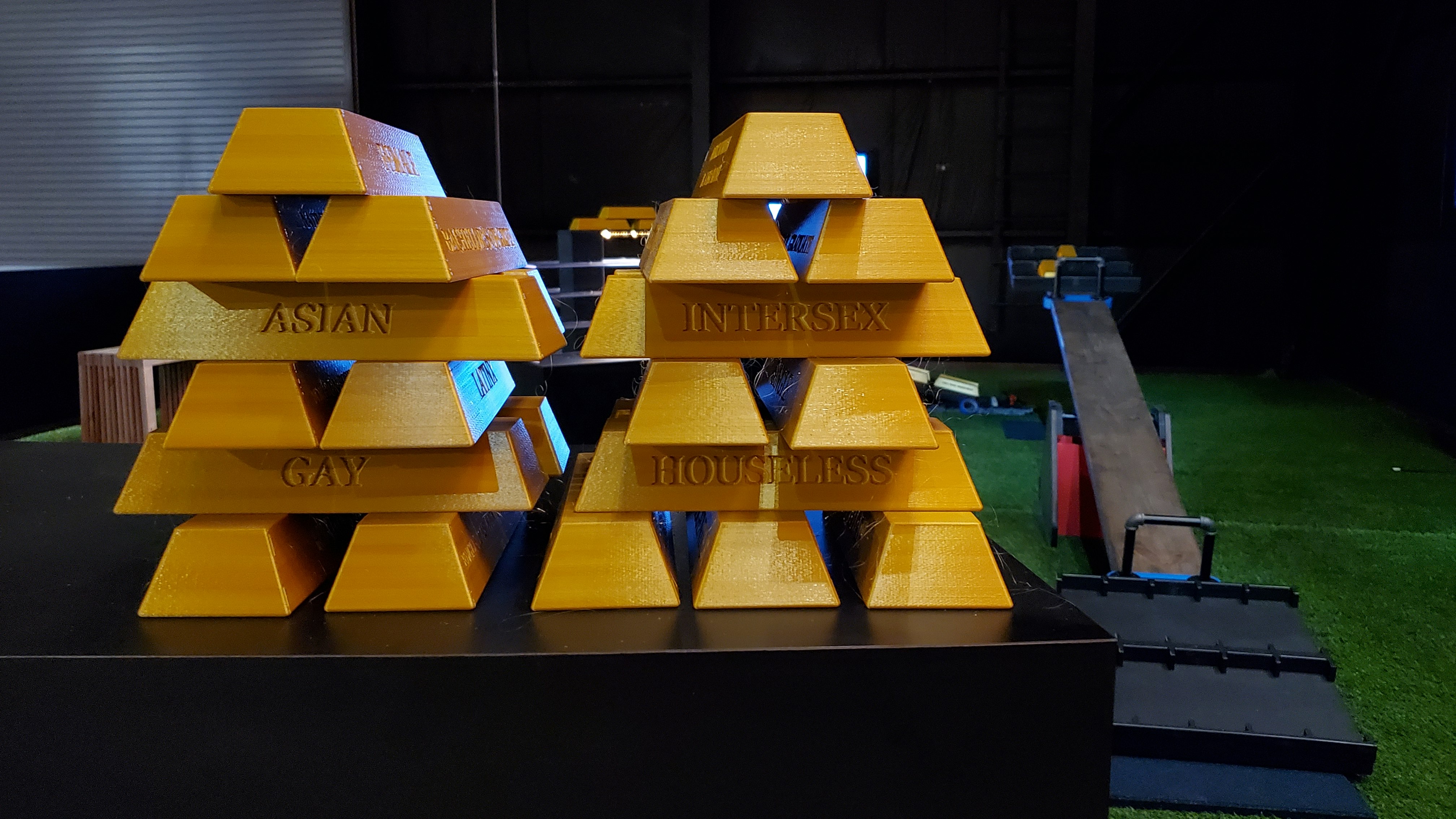 Original display of gold bullion bars with identity terms engraved on them in the SEESAW installation..