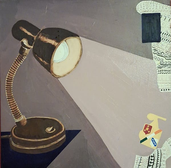 The Darkest point is directly under the lamp.