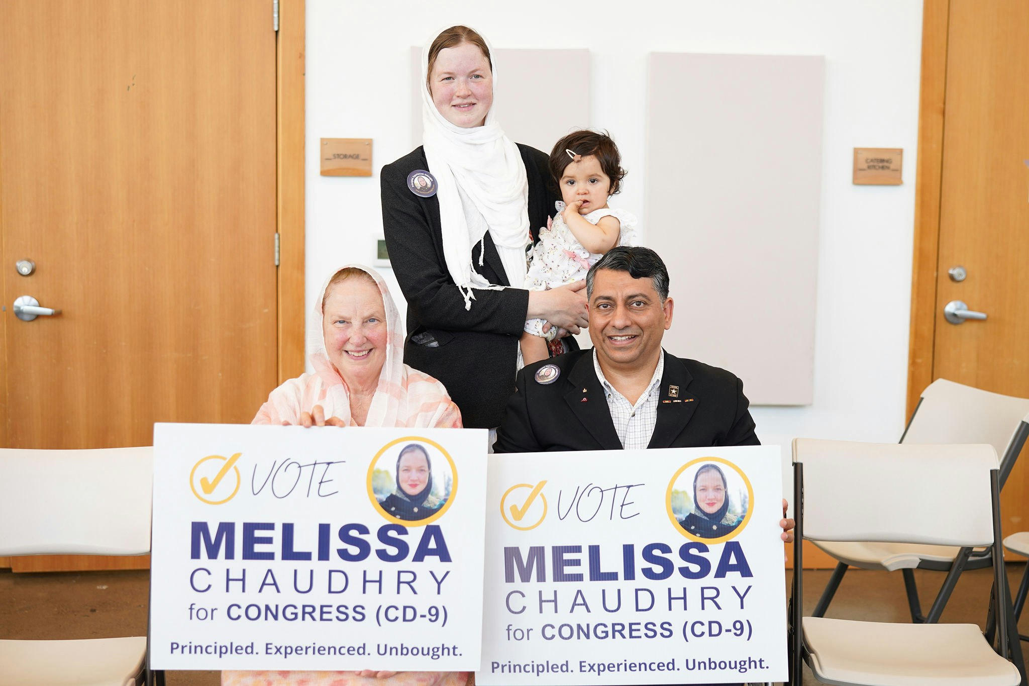 Zahid, Ann, Melissa, and Salma hold campaign signs during Melissa's 2024 run for Congress. Melissa is pregnant with Adil.