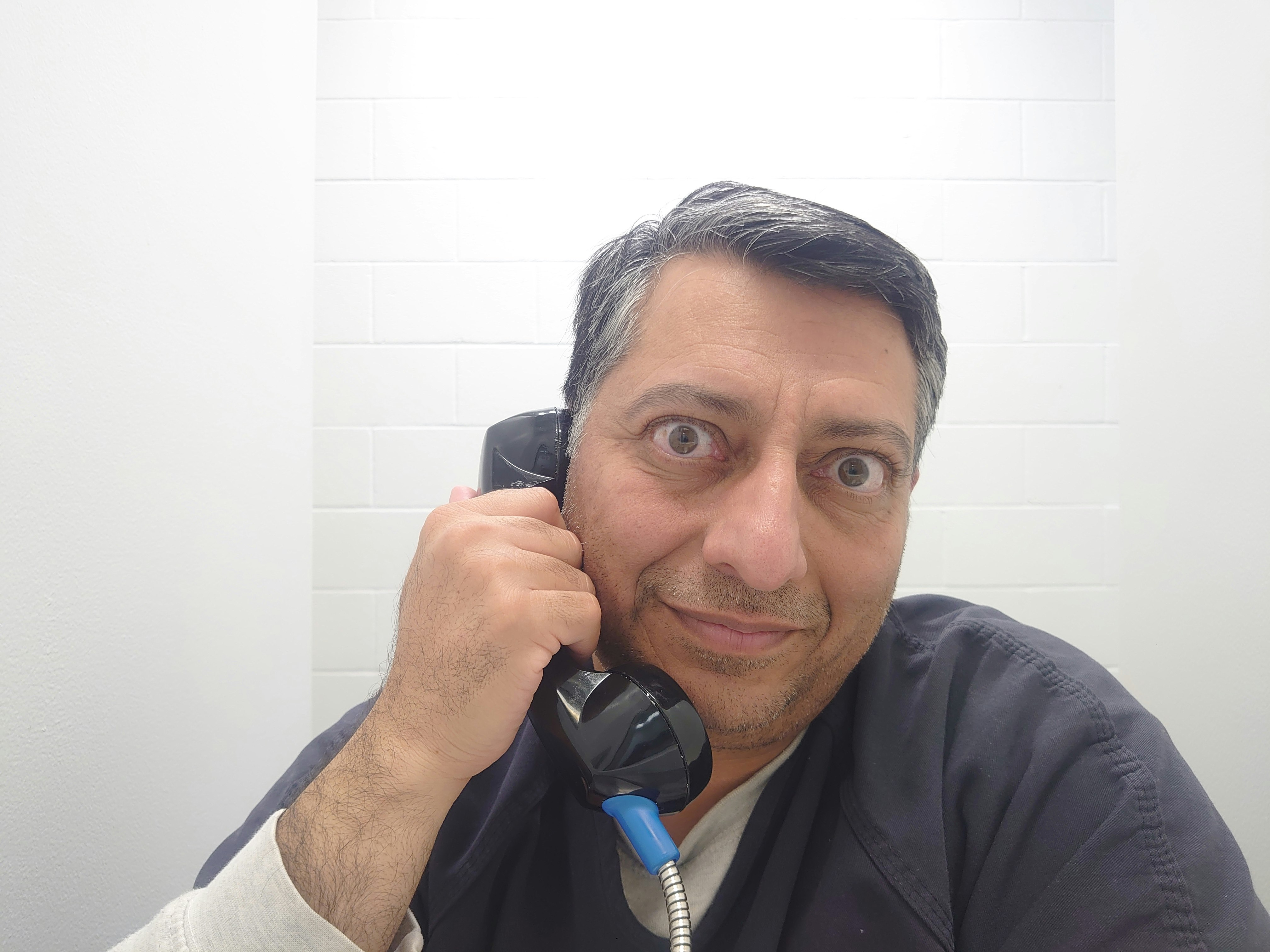 M. Zahid Chaudhry, US Army, Retired: behind the glass, over the phones, hemmed in by blank white concrete walls, eyes bulging from the untreated eye disease the detention center wouldn't provide him care for.