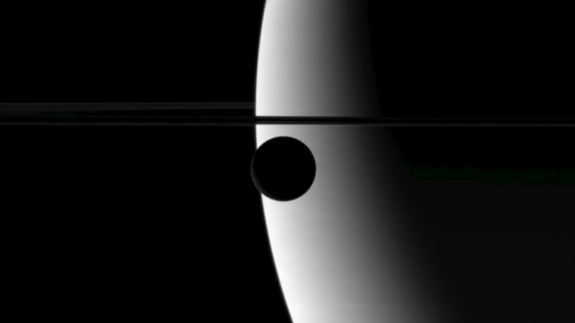Enceladus over Saturn