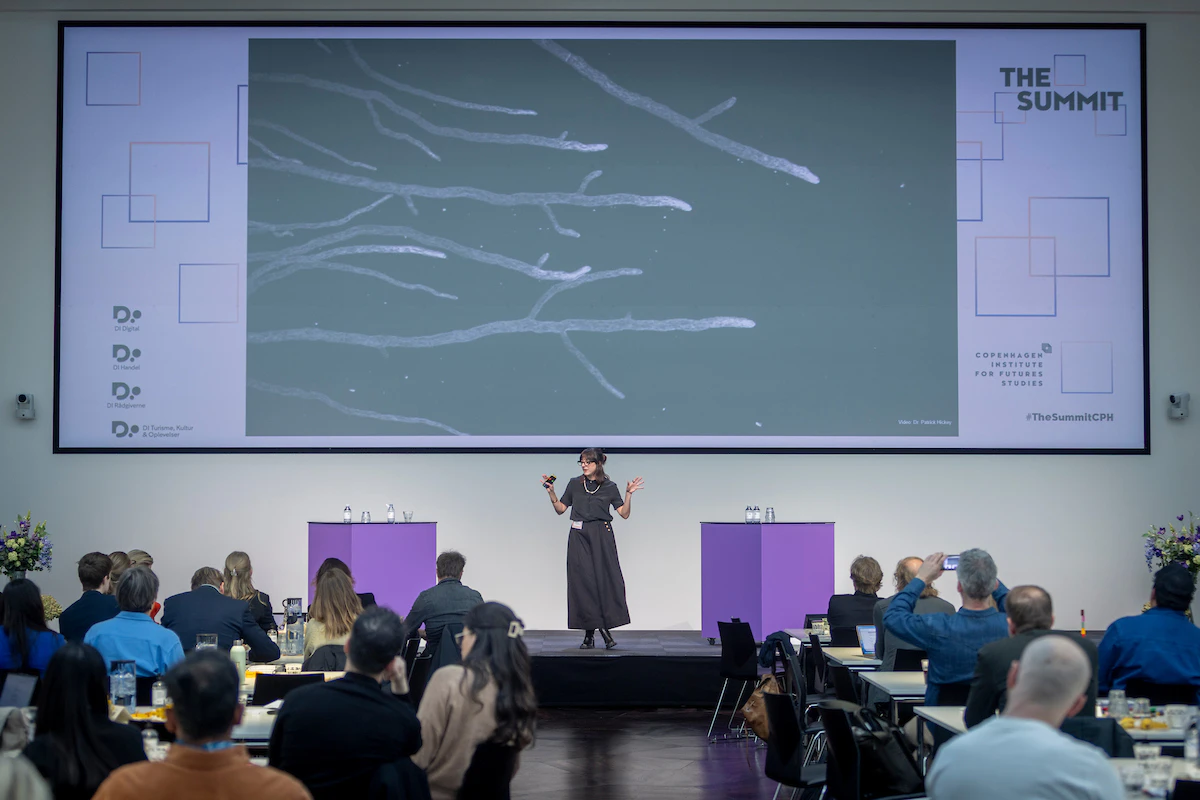 Sporesight Foundress Jess Jorgensen invites a room of Nordic leaders to embody a decomposer fungi, at the 2026 The Summit hosted by CIFS and DI.