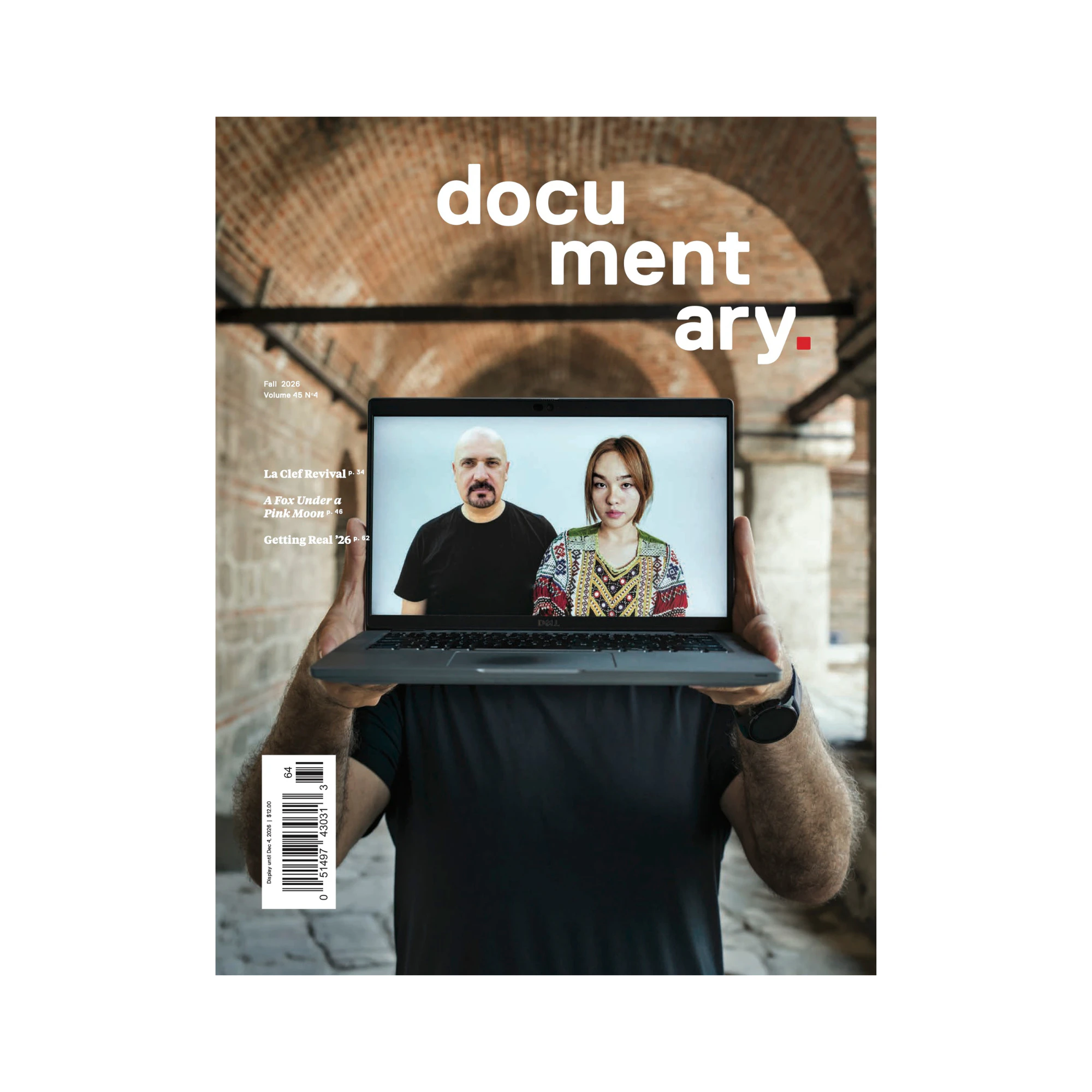 Cover of Documentary magazine's Fall issue features a man in a black t-shirt whose face is obscured by the laptop he's holding, which is displaying a photo of a middle-aged bald man with a dark goatee in a black t-shirt next to a young woman with red hair pulled back wearing a colorful, beaded shirt.