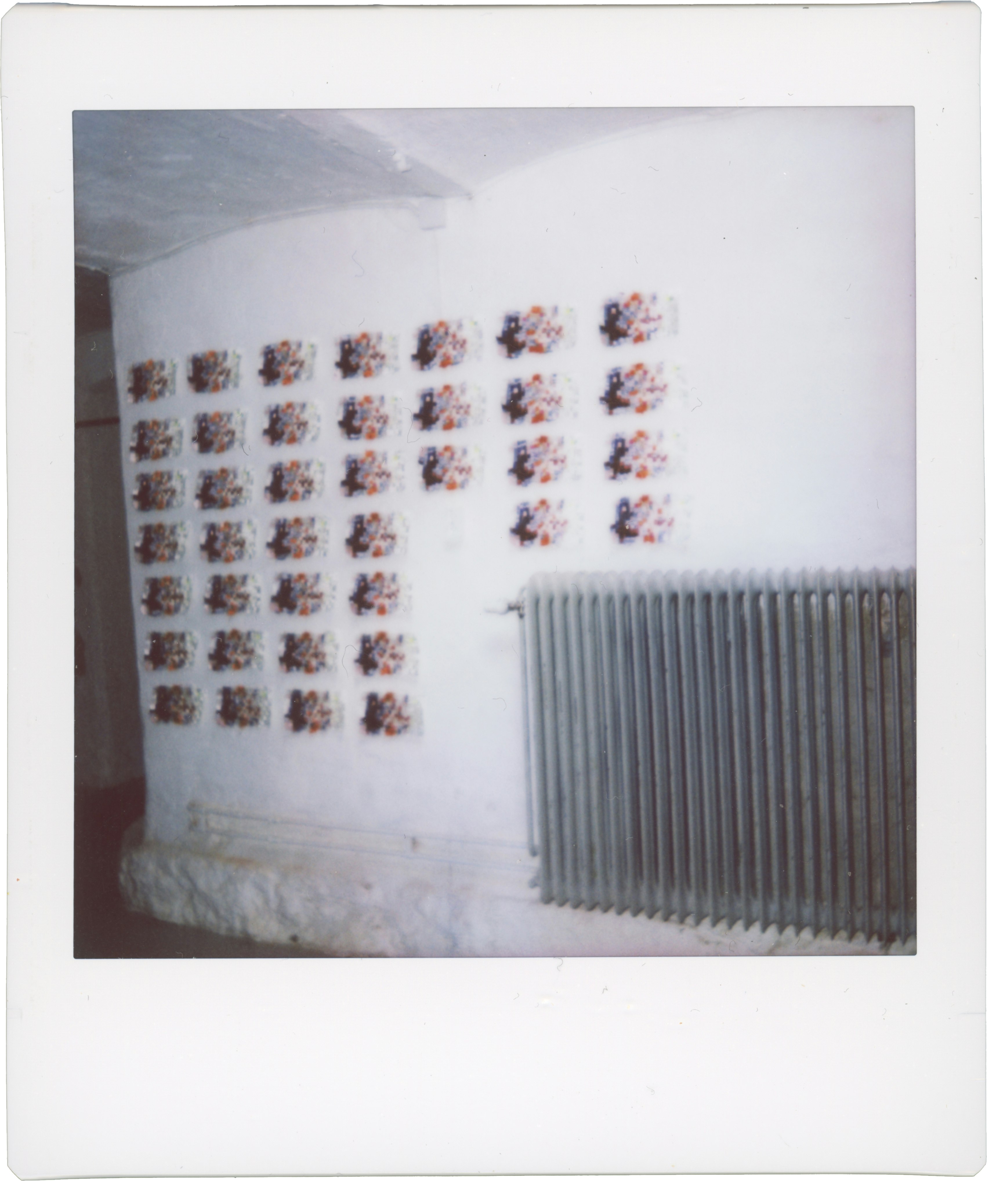 An Instax image of Streamlined Crypto next to a radiator.