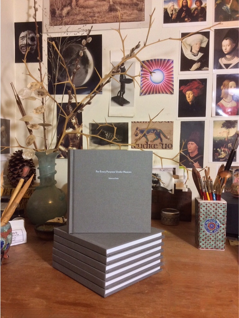 Photo from artist's studio displaying physical copies of book.