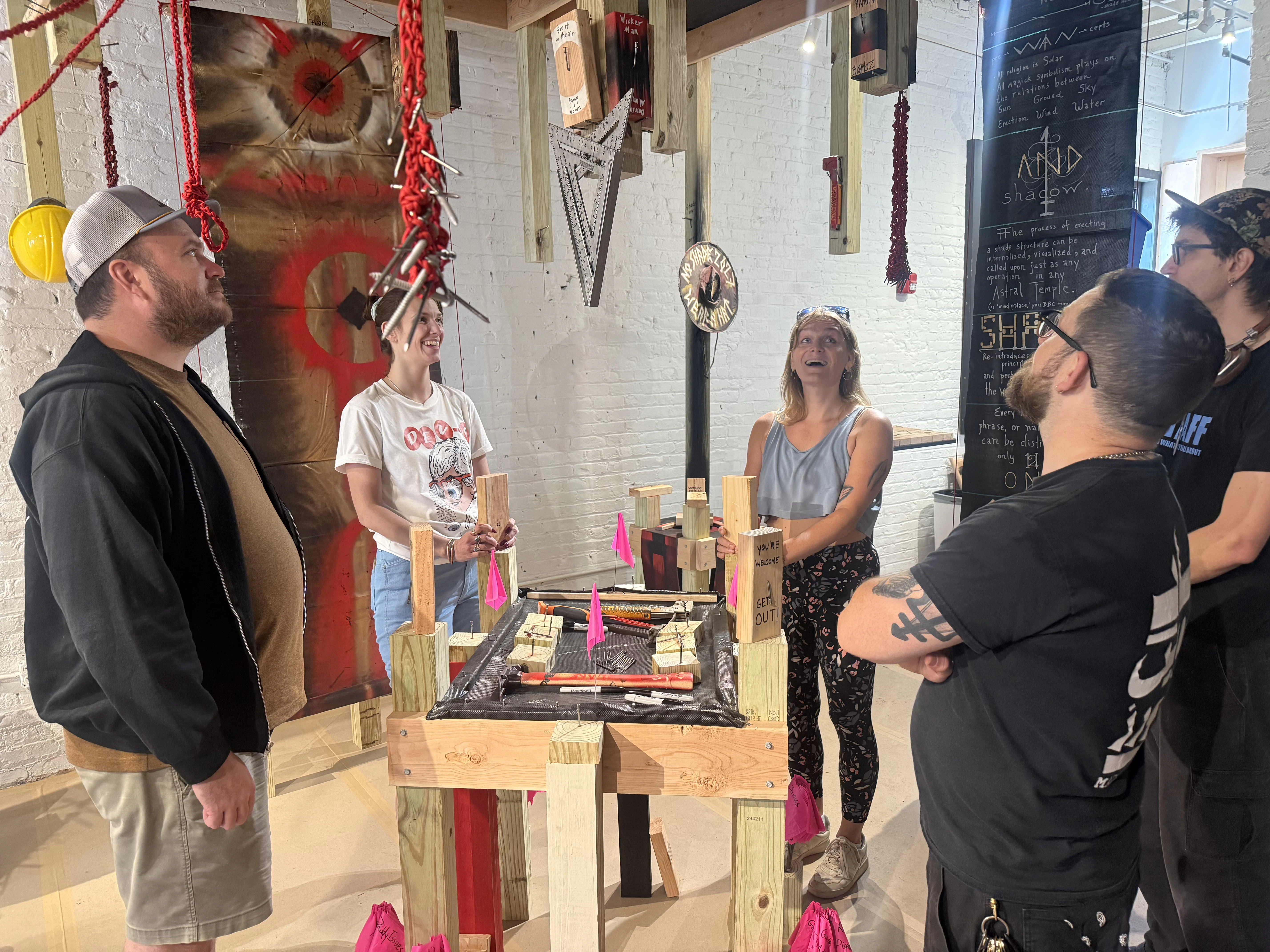 Visitors conduct the ritual to create Shade Switches in the installation "Shenclave Actual," July 27, 2026