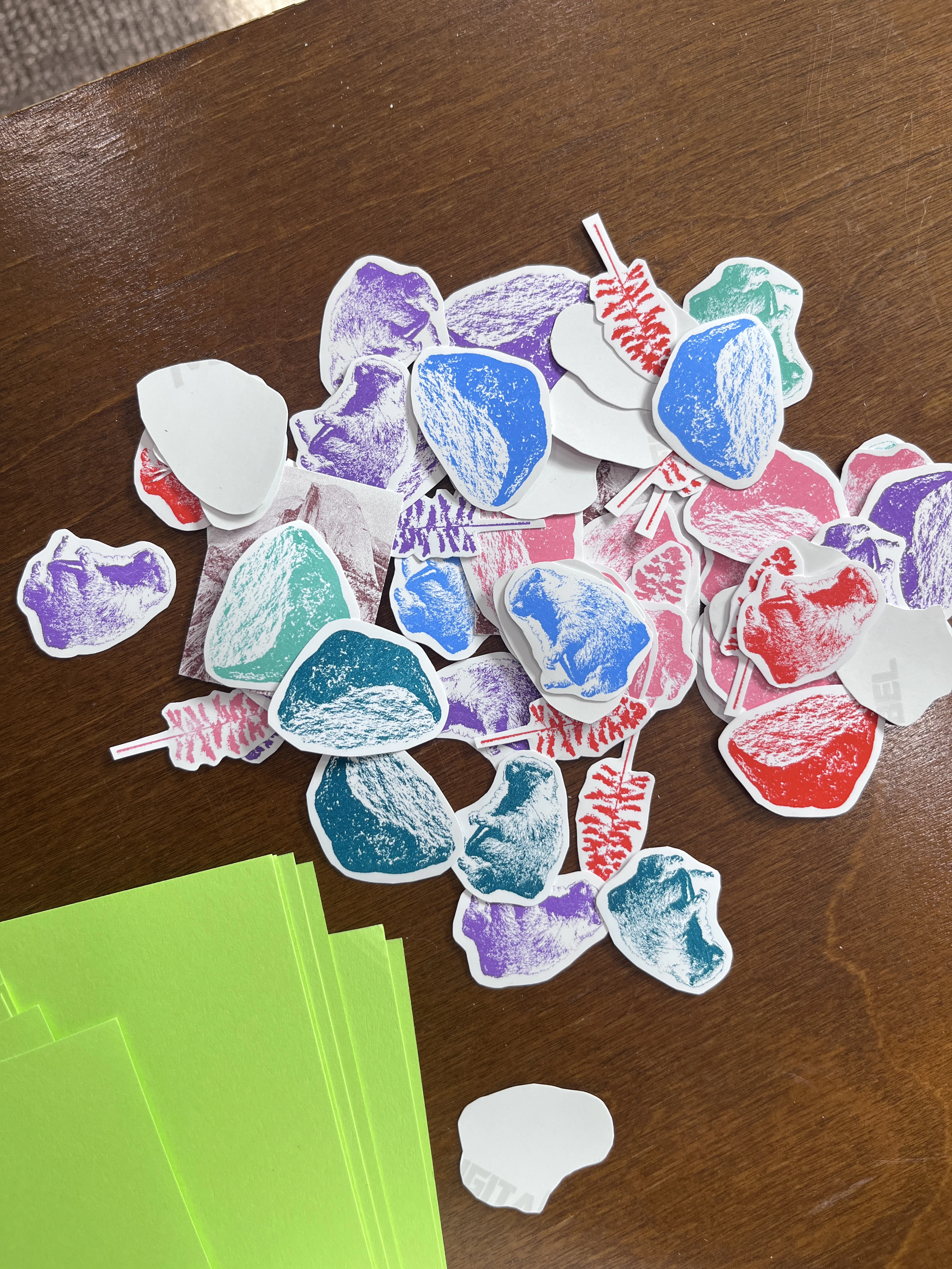 Four stickers will be chosen in random colors. The stickers are a marmot, rock, tree, and smaller version of postcard. 